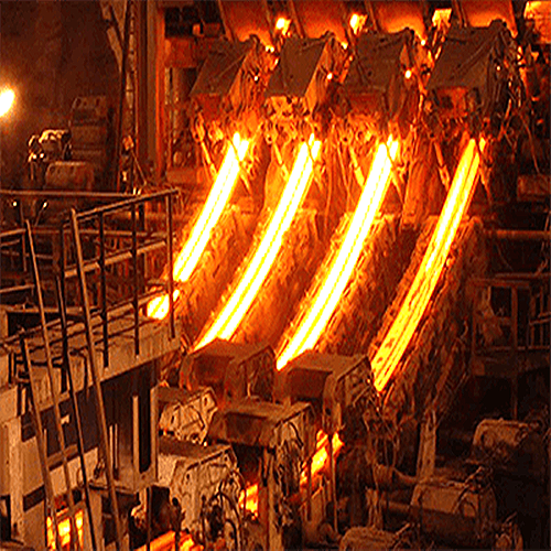 Continuous casting machine running four glowing strands of steel